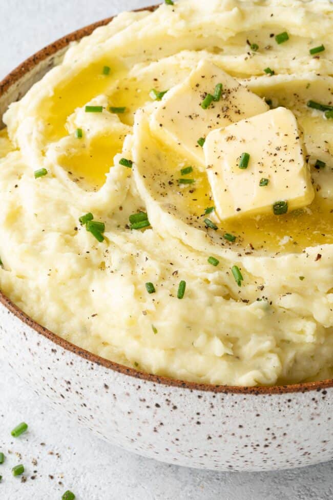 A brown and white bowl filled with Boursin mashed potatoes