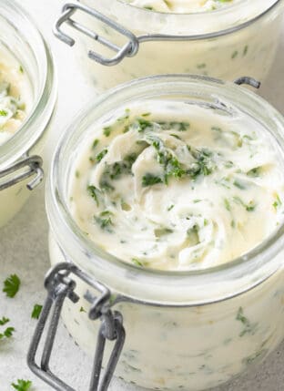 A glass ramekin filled with Roasted Garlic Butter.