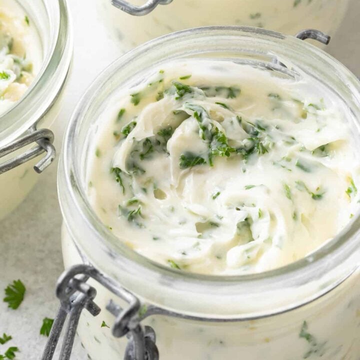 A glass ramekin filled with Roasted Garlic Butter.