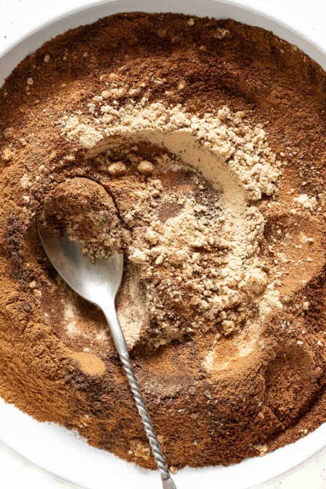 A white bowl filled with a mixture of seasonings.