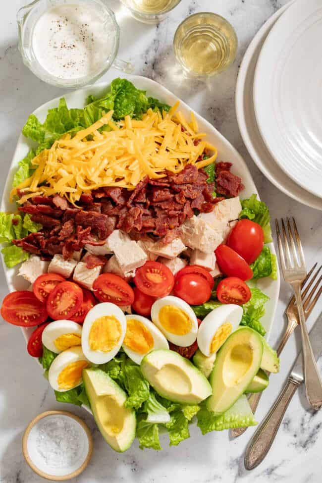 A white platter filled with turkey cobb salad