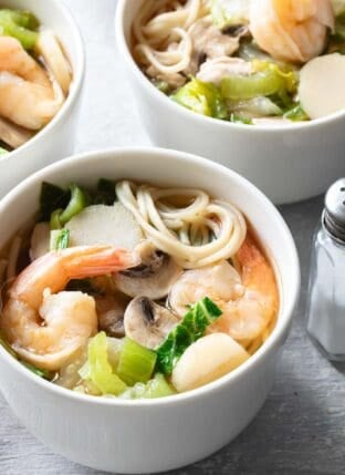 Two white bowls filled with Chinese Noodle Soup.