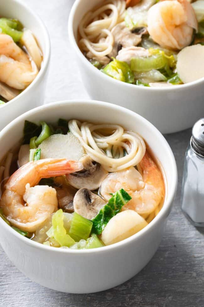 Two white bowls filled with Chinese Noodle Soup.