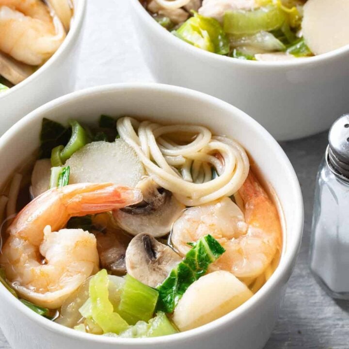 Two white bowls filled with Chinese Noodle Soup.