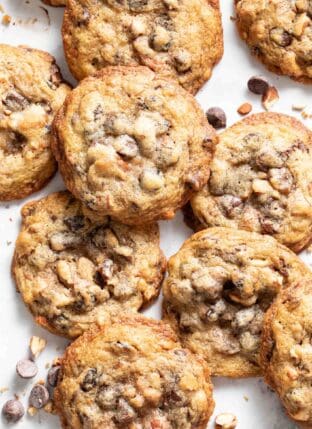 Several cookies scattered on a white counter top.