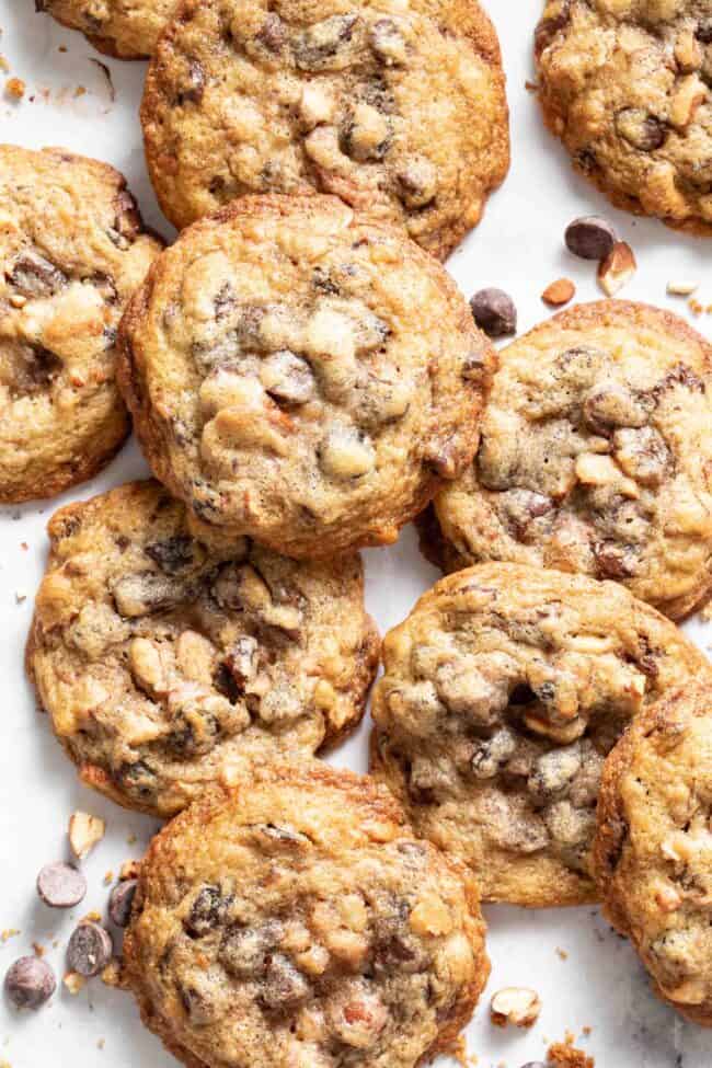 Several cowboy cookies on a white counter top.