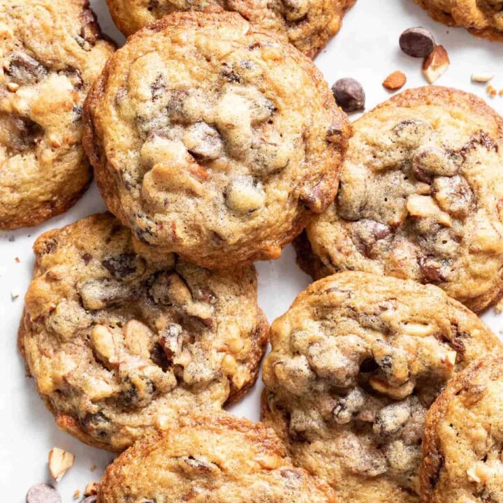 Several cookies scattered on a white counter top.