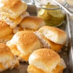 Several tuna melt sliders on a cookie sheet.