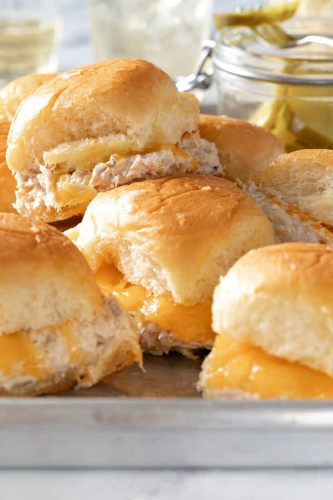 A cookie sheet filled with tuna sliders.