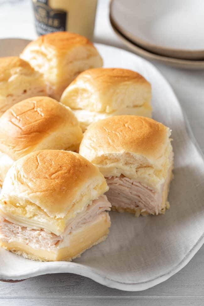 A light gray platter filled with turkey sliders.