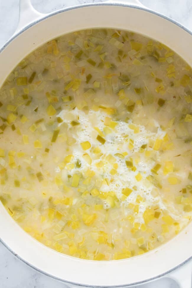 A large white pot filled with creamy soup.