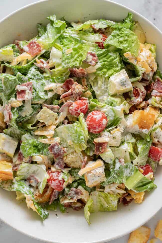 A white bowl filled with BLT chopped salad.