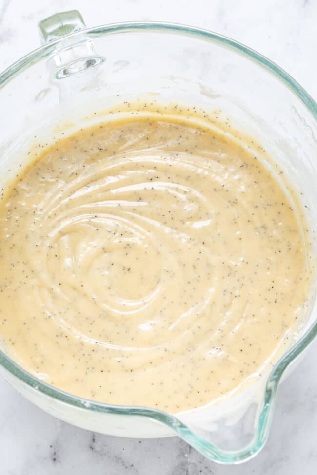 A clear glass mixing bowl filled with batter.