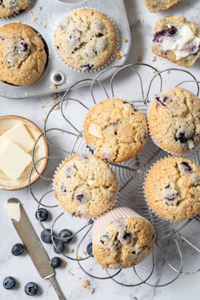 Blueberry muffins cooling on a wire cooling rack.