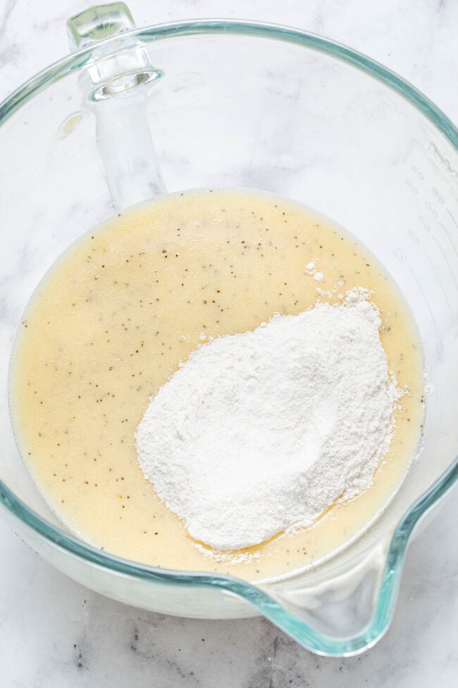 A clear glass mixing bowl filled with batter.