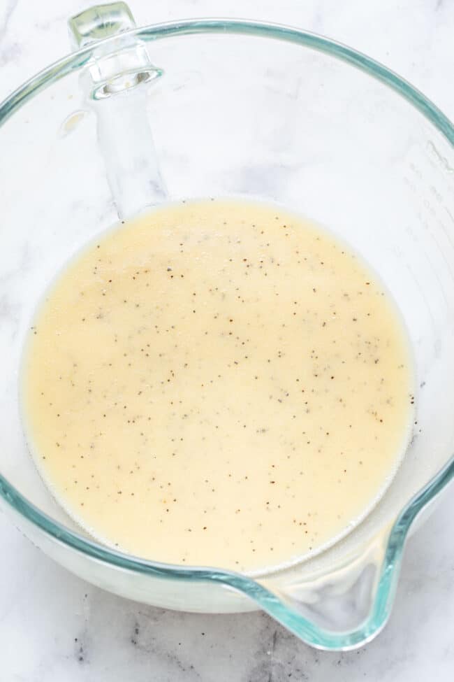 A clear glass mixing bowl filled with batter.