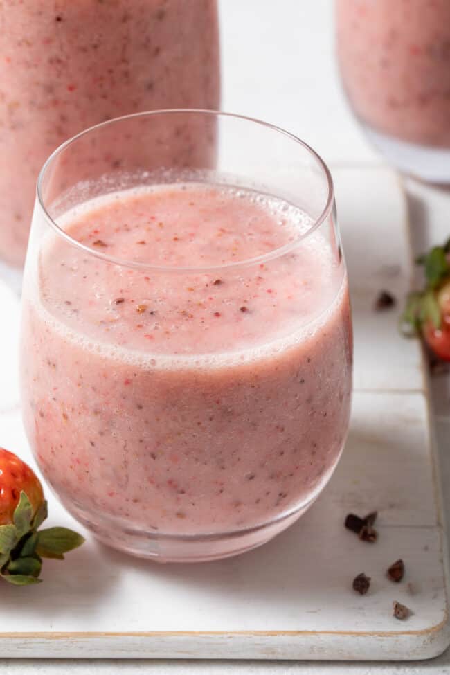 Three clear glasses filled with Strawberry Cacao Nibs Smoothie.