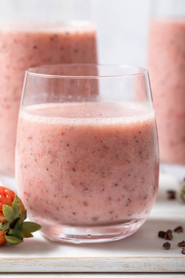 Three clear glasses filled with Strawberry Cacao Smoothie