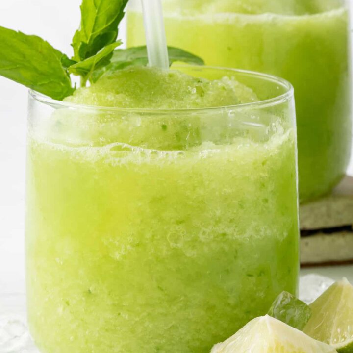 Two clear glasses filled with Cucumber Slushie.