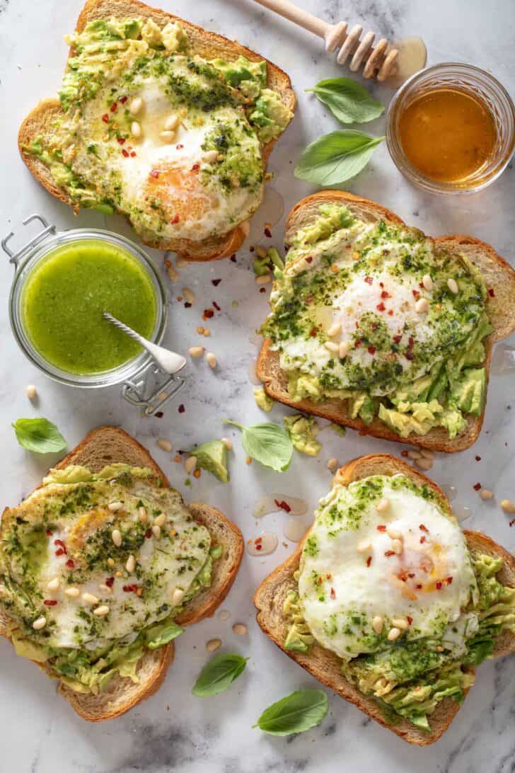 Four pieces of bread topped with green sauce.