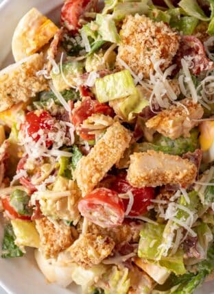 A white bowl filled with Crispy Chicken Salad.