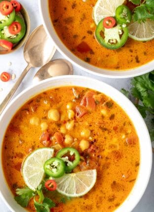 Two white bowls filled with Chickpea Coconut Curry Soup.
