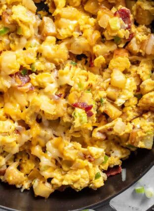 A black skillet filled with Breakfast Scramble with potatoes.