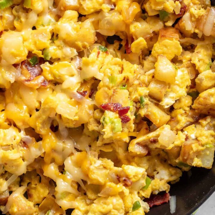 A black skillet filled with Breakfast Scramble with potatoes.