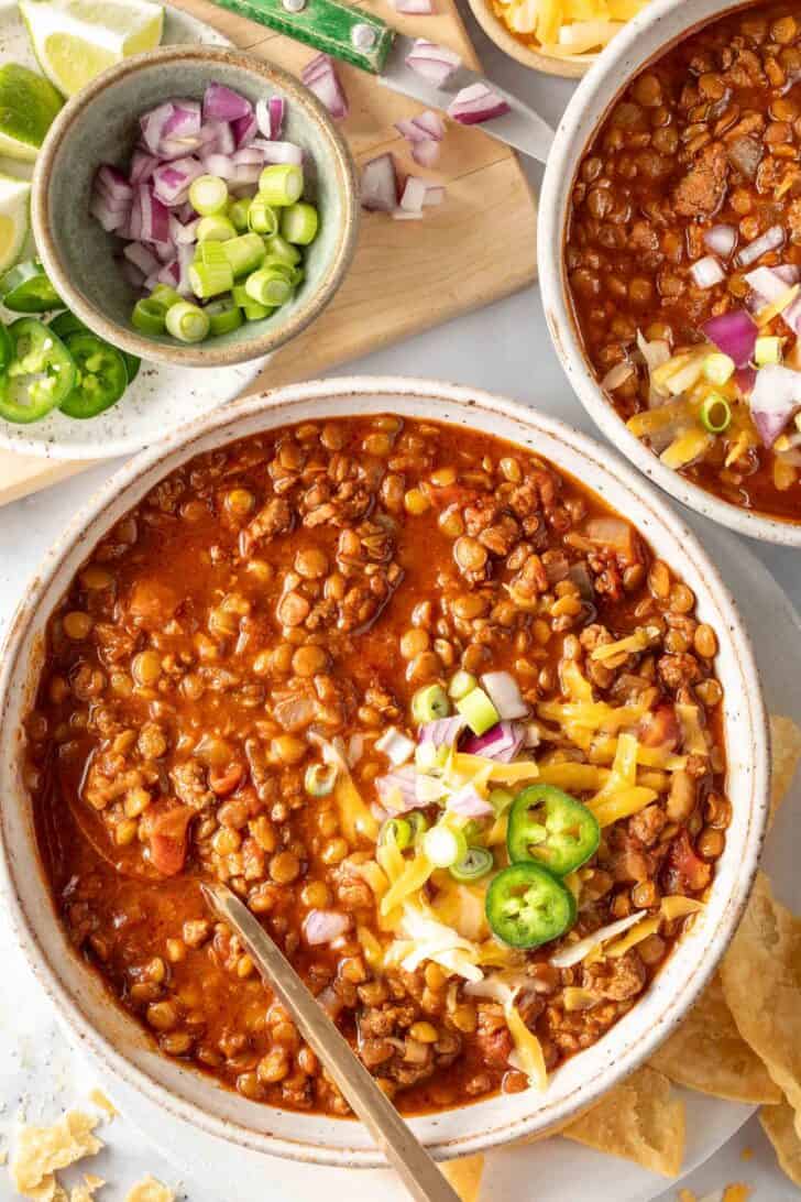 Two bowls filled with turkey chili with lentils.