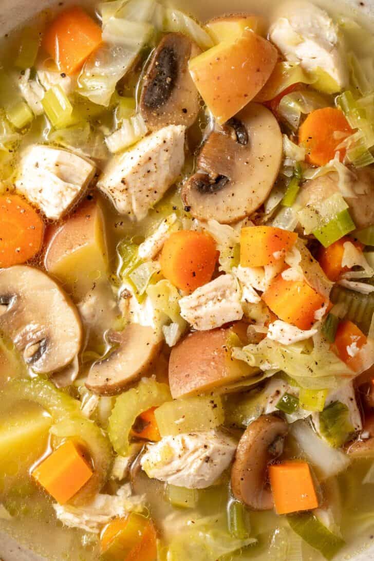 A pot of chicken and cabbage soup.