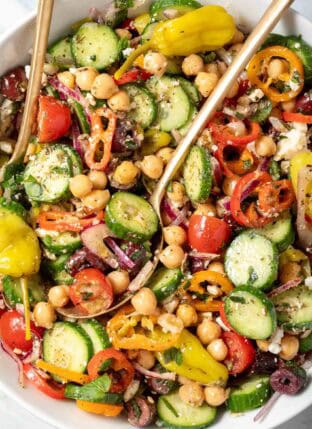 A white bowl filled with Greek Chickpea Salad