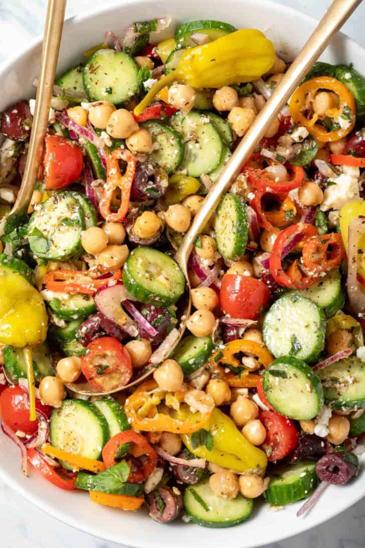 A white bowl filled with Greek Chickpea Salad.