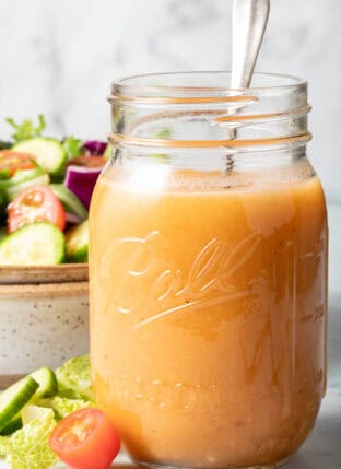 A clear mason jar filled with Chipotle Honey Vinaigrette.