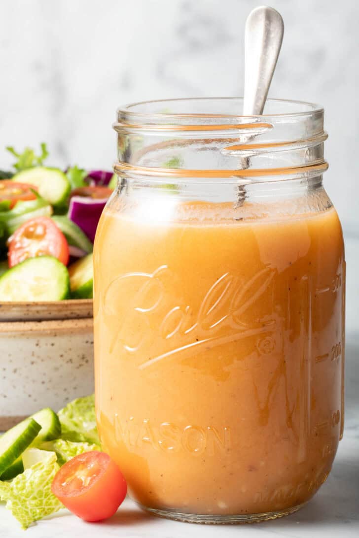 A clear glass mason jar filled with Chipotle Honey Vinaigrette.