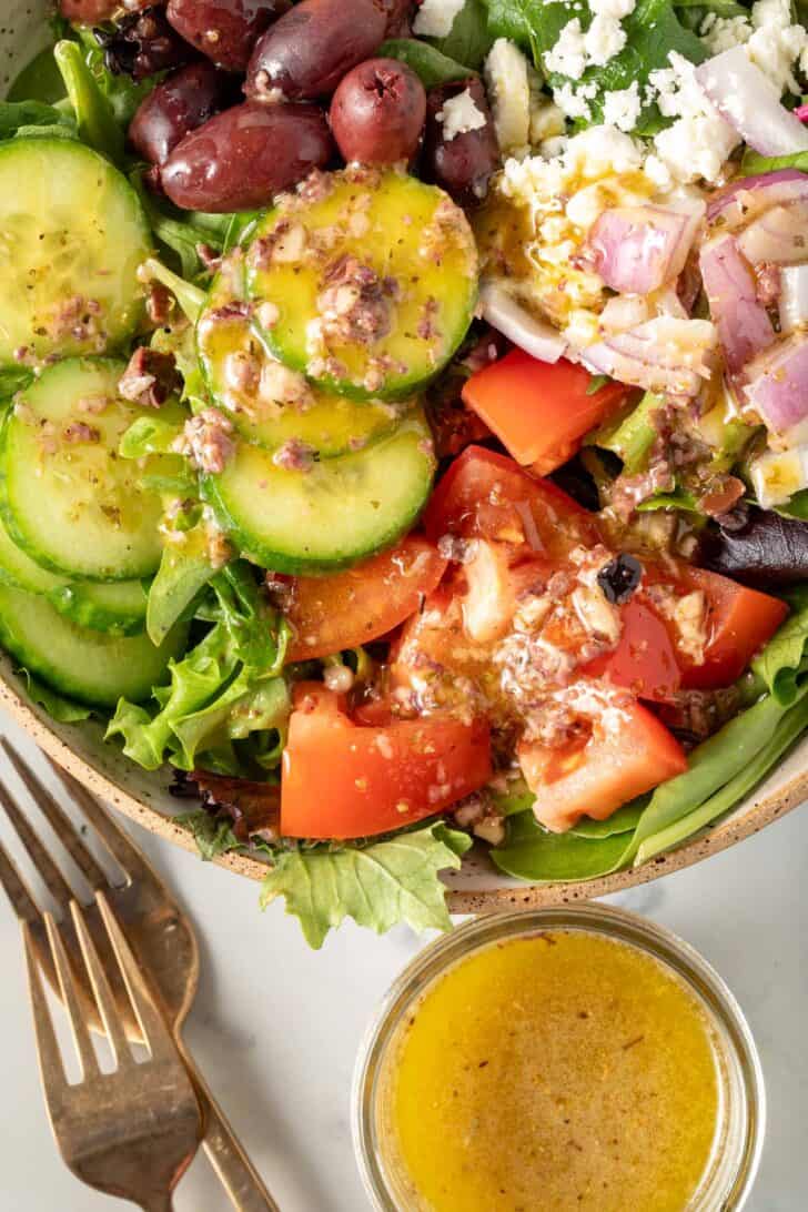 A bowl of salad tossed with the best Greek Vinaigrette Dressing.
