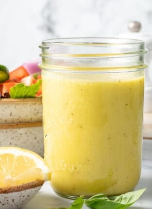 A clear mason jar filled with Lemon Vinaigrette.