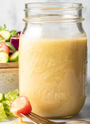 A clear mason jar filled with Sherry Vinaigrette.