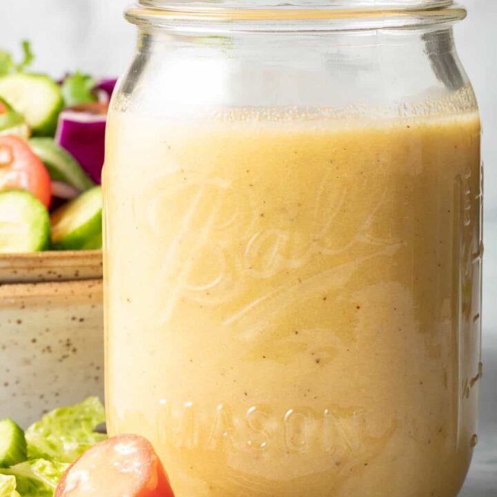 A clear mason jar filled with Sherry Vinaigrette.