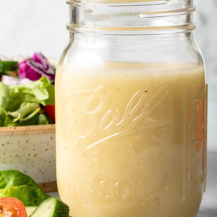 A clear glass mason jar filled with White Balsamic Vinaigrette Dressing.