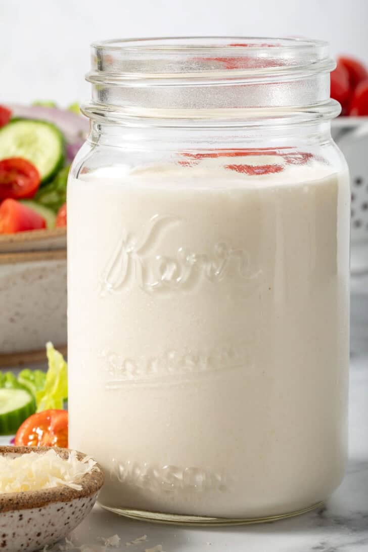 A mason jar filled with Buttermilk Dressing.