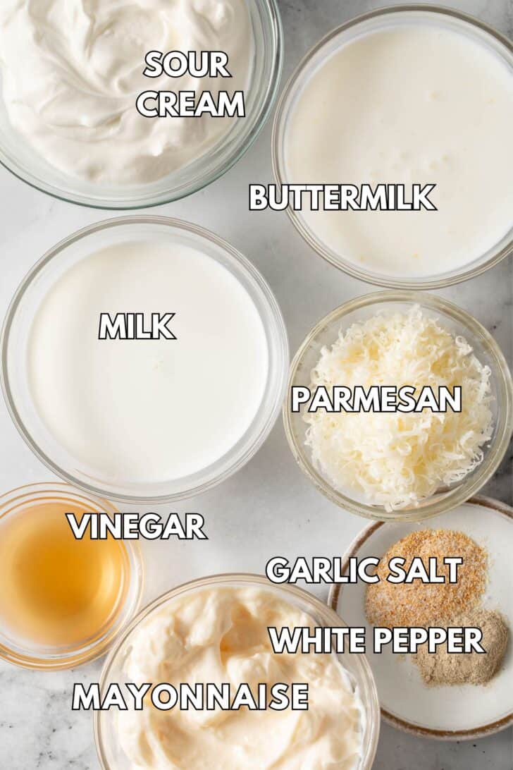 Small glass bowls filled with sour cream, Parmesan cheese, mayonnaise, vinegar and seasoning.