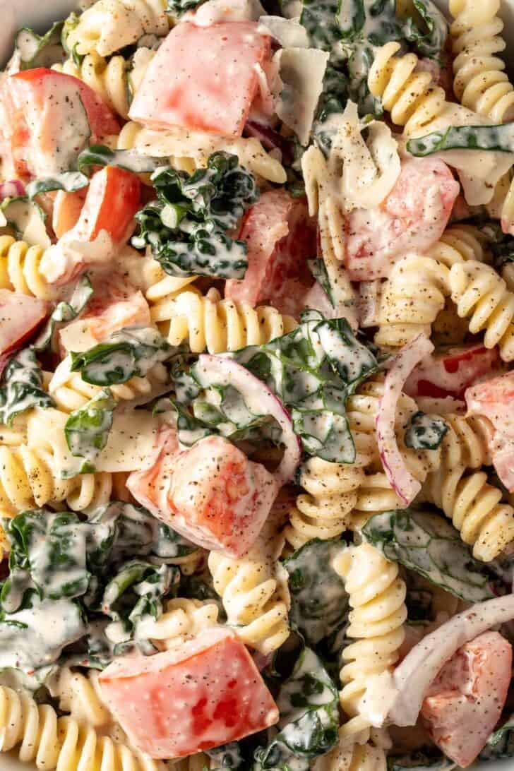 A white bowl filled with Mediterranean Pasta Salad.