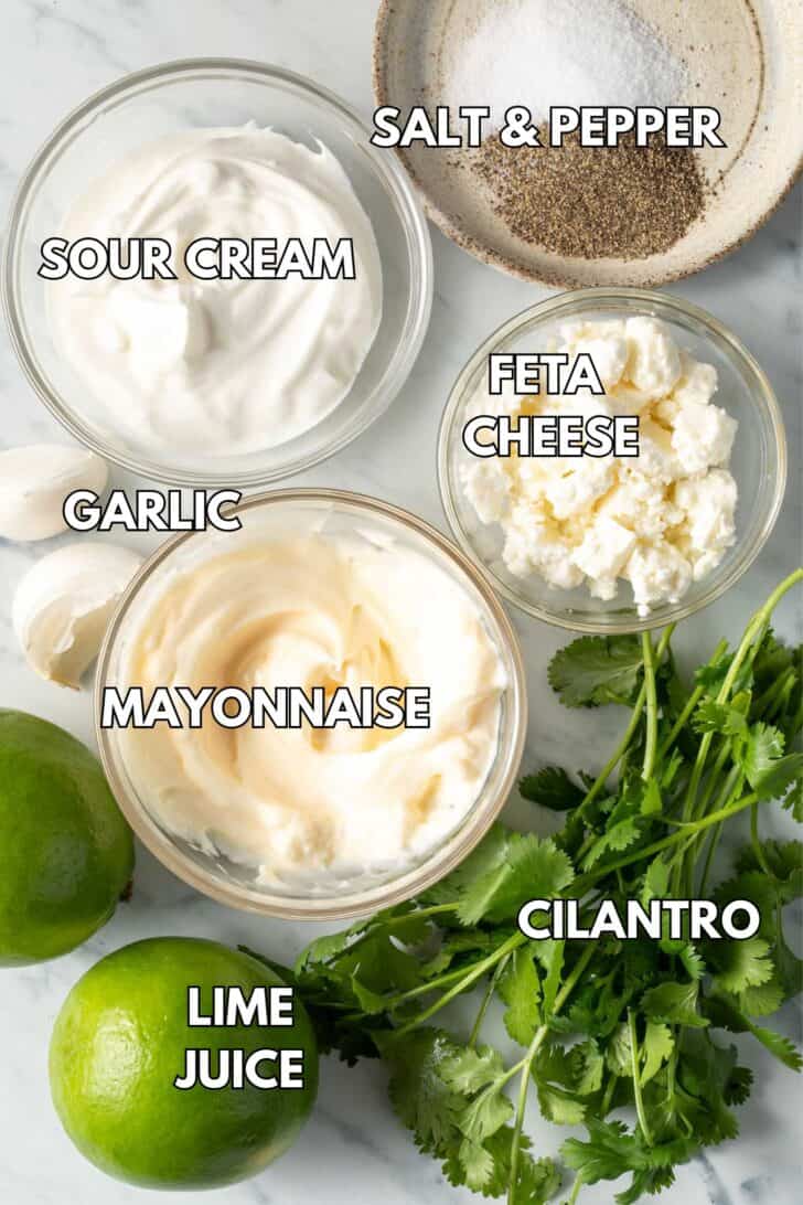 Clear glass bowls filled with mayonnaise, sour cream, and feta cheese. 