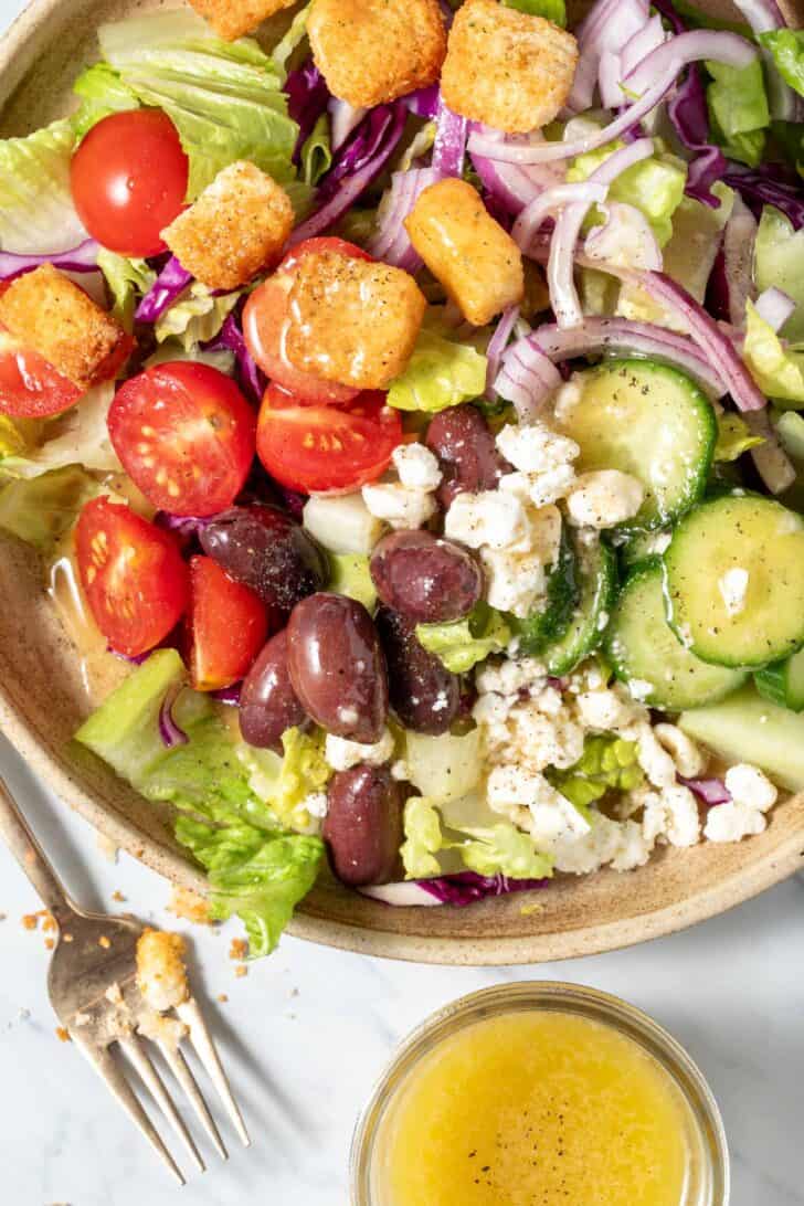 French Vinaigrette Salad Dressing French vinaigrette salad dressing drizzled over a salad in a bowl.