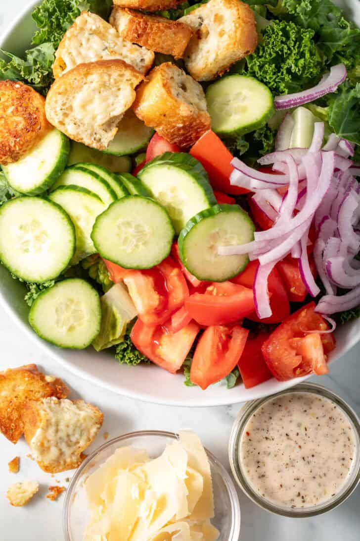 A white bowl filled with a simple Italian Kale Salad.