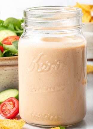 A clear mason jar filled with Southwest Ranch Dressing.