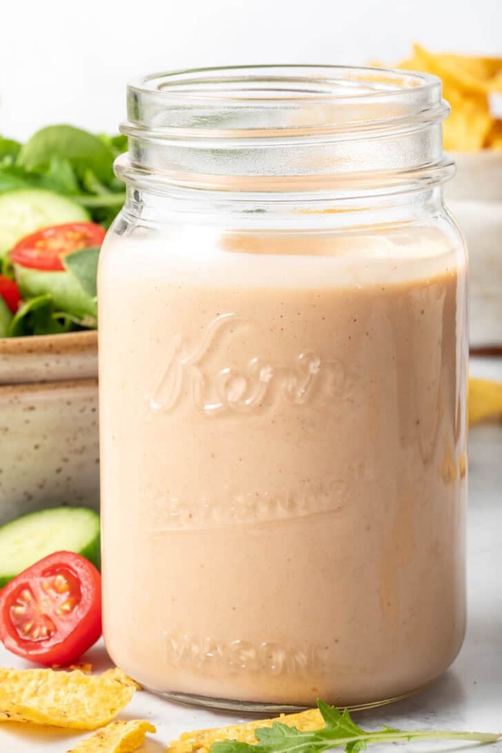 A clear mason jar filled with Southwest Ranch Dressing.