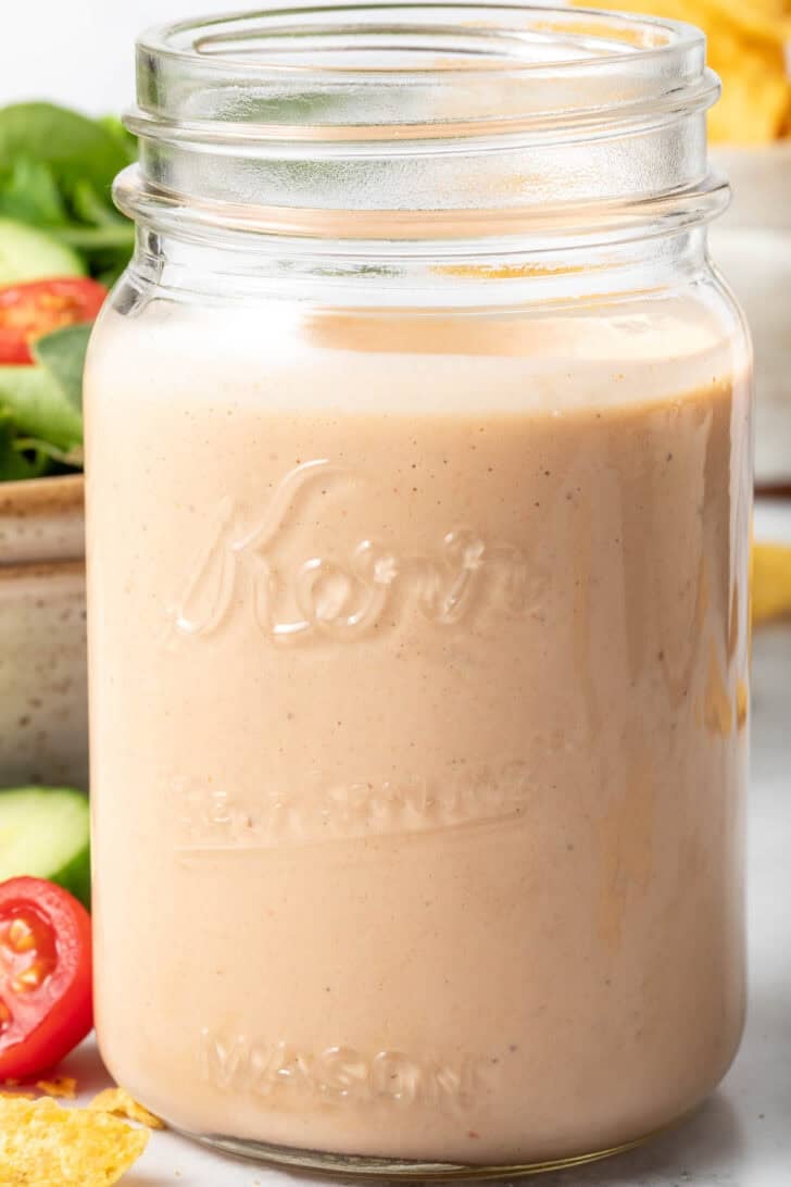 Clear glass mason jar filled with Southwest Ranch Dressing.