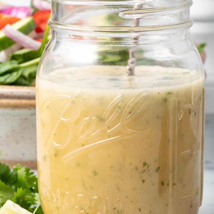 A clear mason jar filled with Asian Salad Dressing.