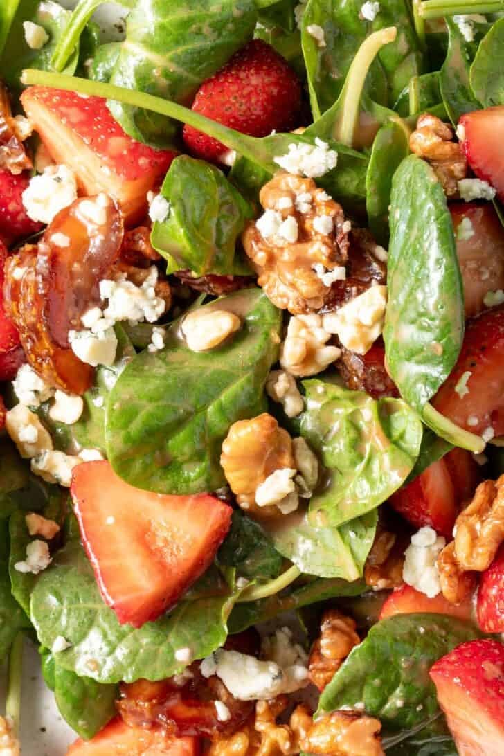 A white plate filled with the best Strawberry Spinach Salad.